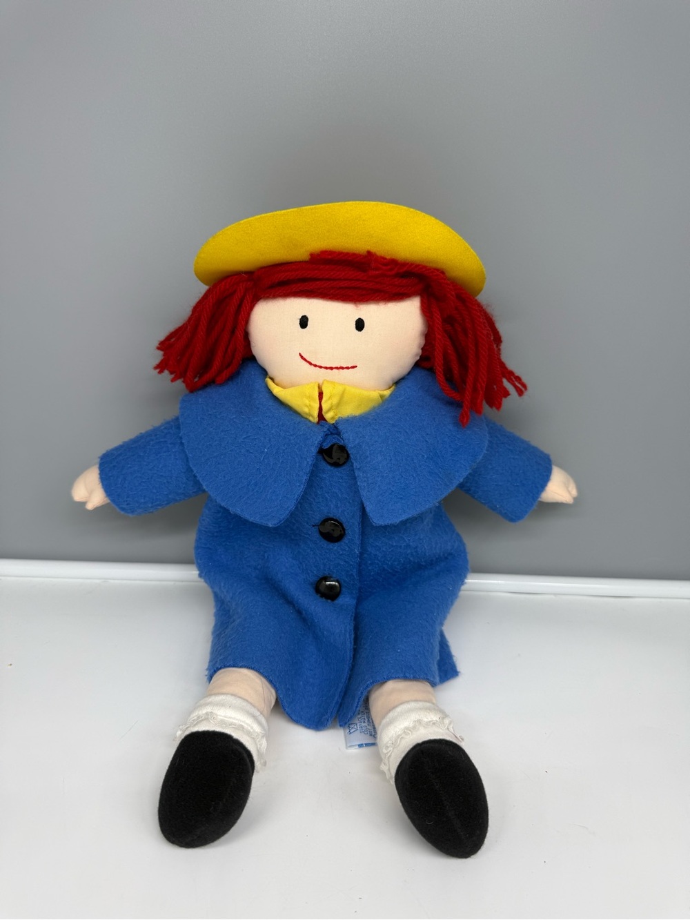 Vintage 1994 Eden Madeline plush doll featuring a felt blue coat and yellow hat